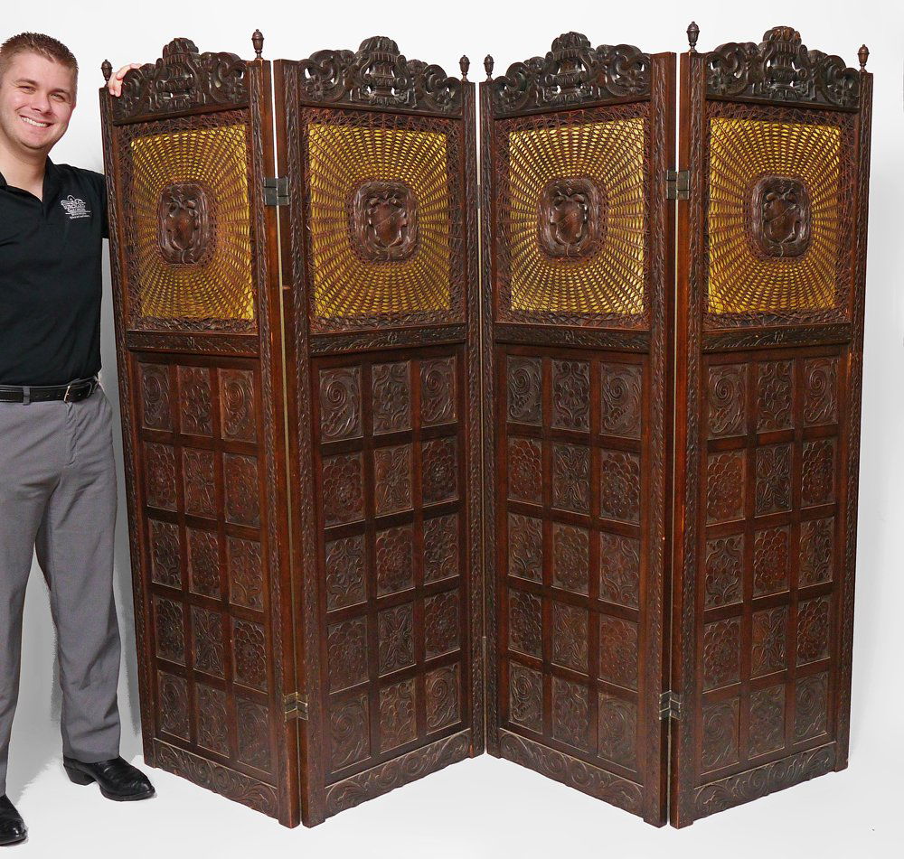 MARSHALL CUTLER CARVED ITALIAN FLOOR SCREEN: MARSHALL CUTLER CARVED ITALIAN RENAISSANCE REVIVAL FLOOR SCREEN: Each of the 4 panels with carved crest with figures over caned screen with central medallion with shield, backed with yellow silk. Lowe