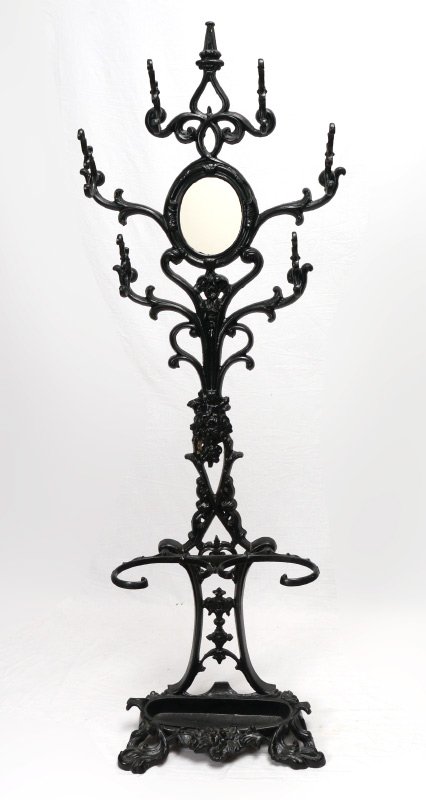 VICTORIAN WROUGHT IRON HALL TREE: VICTORIAN WROUGHT IRON HALL TREE: Black painted with central mirror, 6 coat hooks, floral motif decoration, and lower umbrella hooks. Overall measures 74'' h. x 22'' x 11 1/2''.