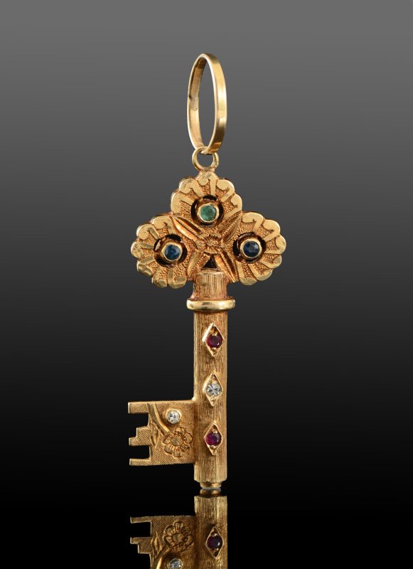 EARLY 20TH C GEM STONE KEY PENDANT 16K GOLD: EARLY 20TH C GEMSTONE FIGURAL KEY PENDANT: 16K yellow gold key pendant set with diamonds, sapphires, rubies and emeralds totaling approx. .47 Ct. Length including the jumbo jump ring is 2.25". Weight 
