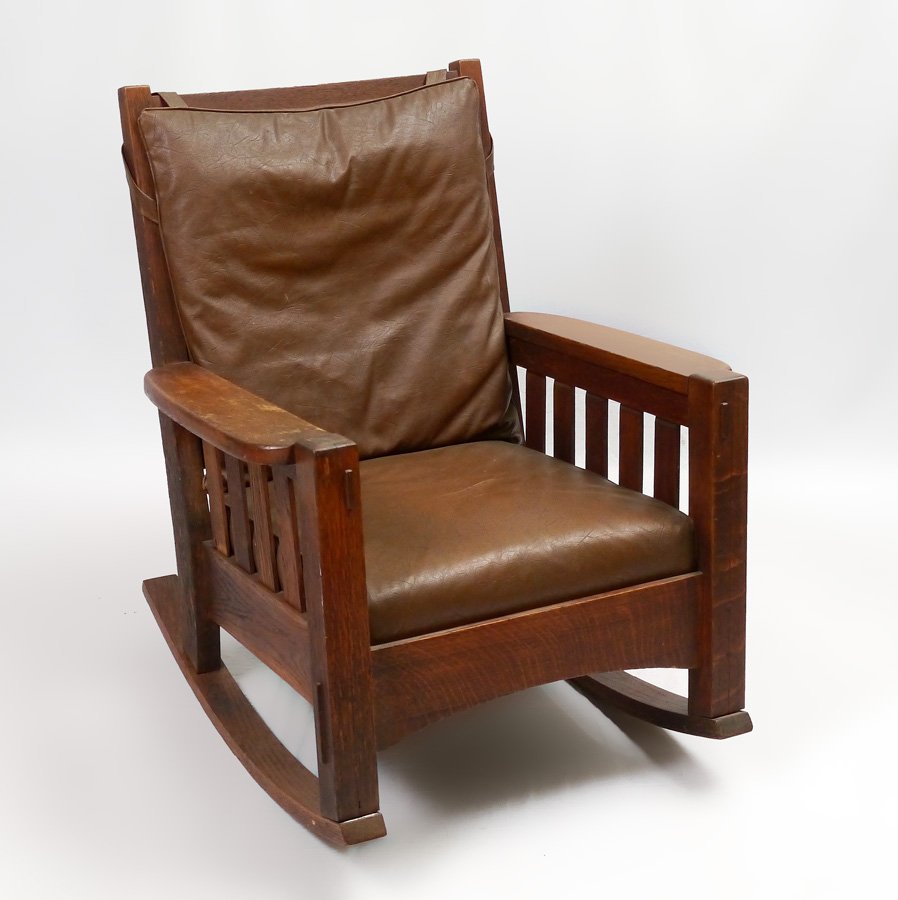 HARDEN ARTS & CRAFTS OAK ROCKER: ARTS & CRAFTS MISSION OAK ROCKER BY HARDEN: Thru tenon construction, vertical slat arm supports, horizontal back splats, curved skirt, spring seat. Measures approx. 39" h. x 31 1/2" x 35".