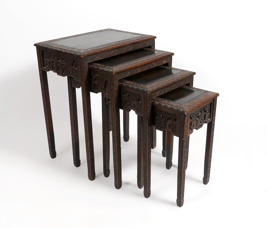CARVED ORIENTAL NESTING TABLES: CARVED ORIENTAL NESTING TABLES: Nest of 4 tables, carved oriental motifs on skirts and legs. Largest measures 26 3/4" h. x 21" x 14 1/4".