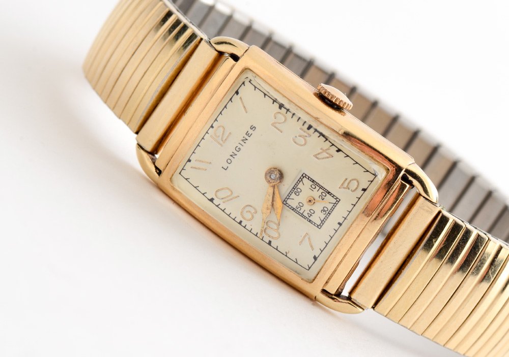 VINTAGE LONGINES TANK WATCH: VINTAGE LONGINES TANK WATCH: Gold filled case with convex crystal, secondary seconds dial. Mechanical movement in working order. Retro fitted with a Speidel band.