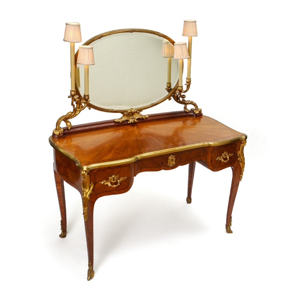 LOUIS XV STYLE FRENCH ORMOLU MOUNTED VANITY: LOUIS XV STYLE FRENCH ORMOLU MOUNTED VANITY: In the manner of Francois Linke, oval ormolu mounted beveled glass mirror supported by bronze foliate form supports, each holding 2 electrified lights. Sha