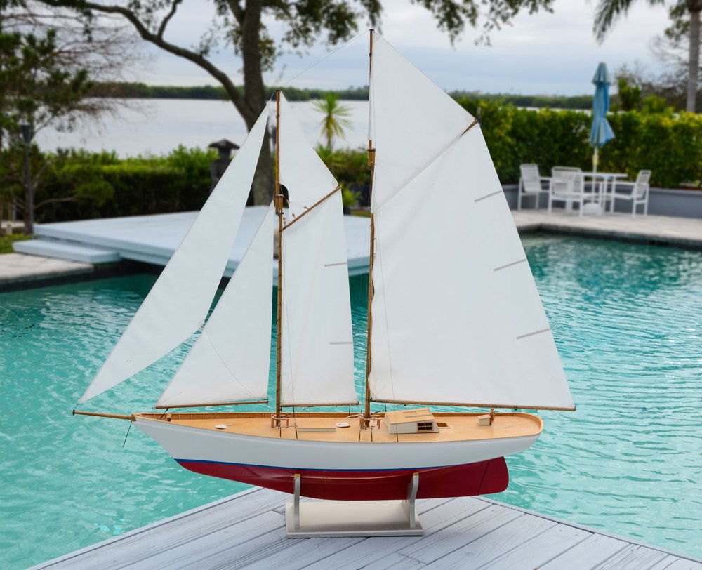 LARGE SAILING BOAT MODEL: LARGE SAILING BOAT MODEL: Dual mast sailboat with spot for radio controlled engine to control sails, engine currently missing. Complete with rigging and sails, hull with white over red. Measures 65 1/