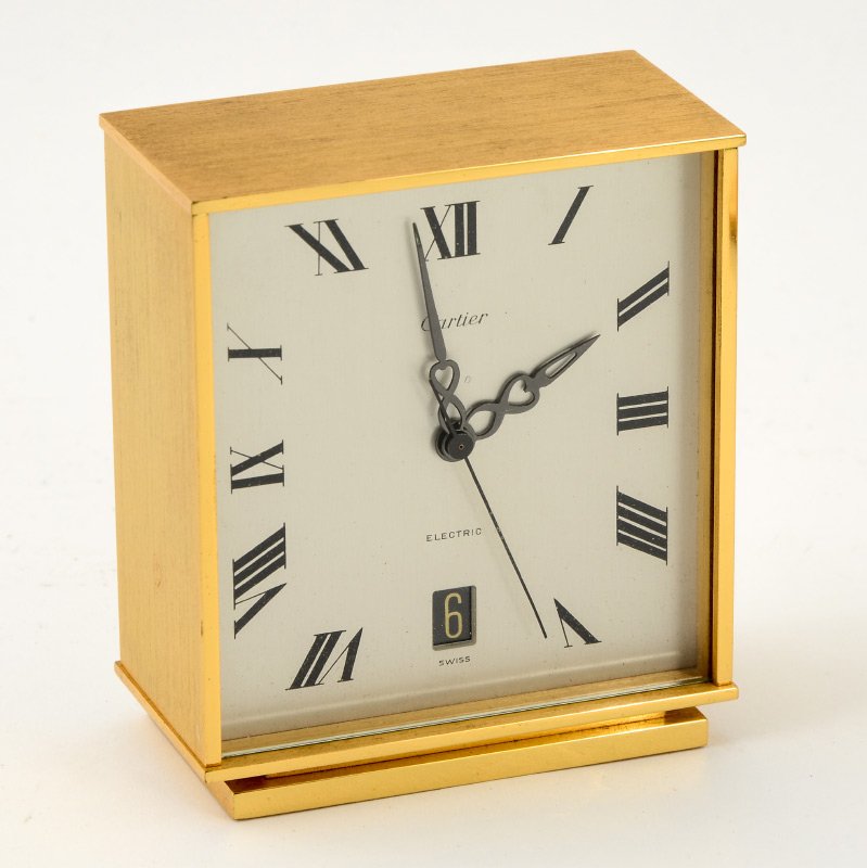 CARTIER ELECTRIC CALENDAR DESK CLOCK BY CONCORD: CARTIER ELECTRIC CALENDAR DESK CLOCK BY CONCORD: Swiss made for Cartier by the Concord Watch Company. Visible calendar and Roman numeral dial. 4" x 3 3/4" x 2".