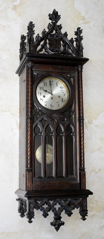 JUNGHANS GOTHIC REVIVAL CARVED WALL CLOCK: JUNGHANS GOTHIC REVIVAL CARVED WALL CLOCK: Architectural gothic revival pediment, fretwork on glass door and lower finials. Silvered dial marked Junghans, time and strike triple key wind movement. Mea