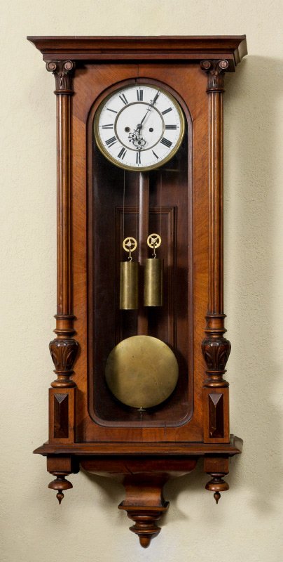 GERMAN DOUBLE WEIGHT REGULATOR WALL CLOCK: GERMAN DOUBLE WEIGHT REGULATOR WALL CLOCK: Walnut veneer case, door with carved and fluted half columns, lower urn finials. Porcelain dial with Roman numerals, double weight time and strike German mov