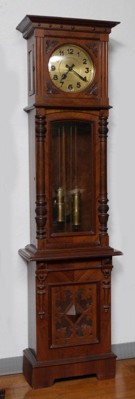 GUSTAV BECKER GERMAN GRANDFATHER CLOCK: GUSTAV BECKER GERMAN GRANDFATHER CLOCK: Case with carved applied decoration, top door with bowed round window over shaped glass window door, applied turned half columns, base with carved and applied d