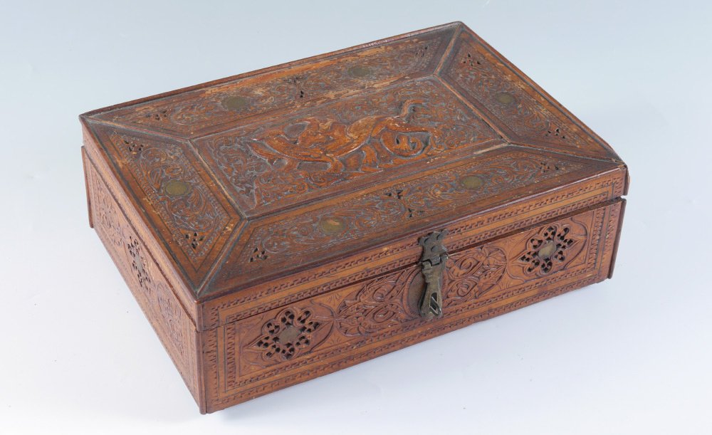 CHINESE FIGURAL CARVED BOX: CHINESE FIGURAL CARVED BOX: Hinged lid with center lion fighting mythical creature design, frame with foliate scroll motifs. Sides with foliate scroll and geometric patterns. Lined interior, measures 