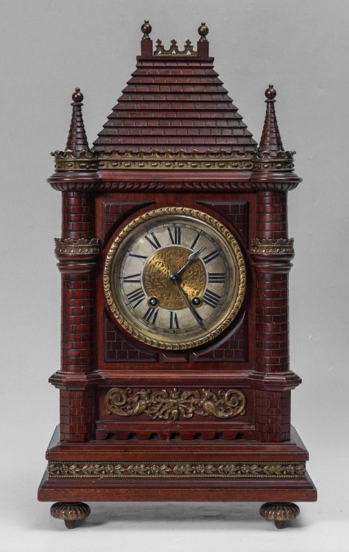 LENZKIRCH CARVED CATHEDRAL MANTLE CLOCK: LENZKIRCH CARVED CATHEDRAL MANTLE CLOCK: Carved wood architectural case, cast metal gallery over stepped top, spire column stiles, applied ormolu decoration, bronze feet. Silvered dial with embossed b
