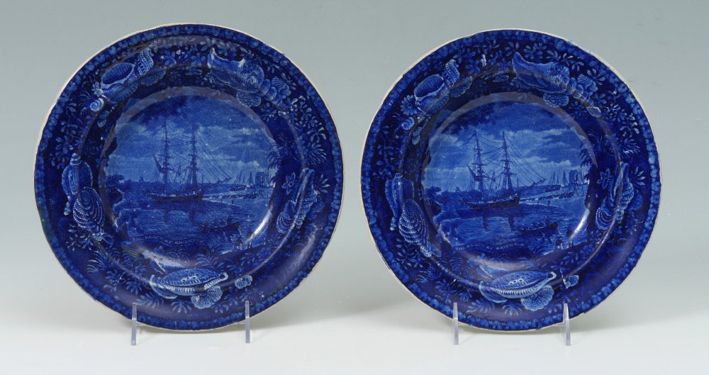 PAIR ENGLISH HISTORICAL FLOW BLUE PLATES: PAIR ENGLISH HISTORICAL FLOW BLUE SOUP PLATES: Both bowls with scene of ships at port titled ''The Beach at Brighton, impressed mark for Wood & Sons Burslem Semi China on back. 10 3/8'' dia.