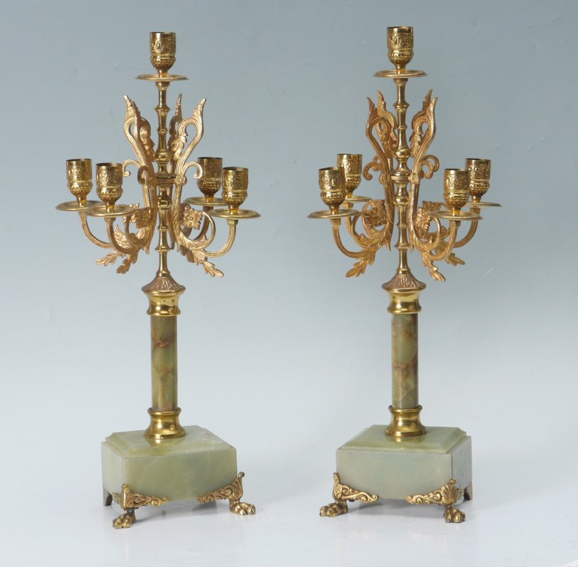 PAIR ONYX & GILT BRONZE CANDELABRA: PAIR ONYX & GILT BRONZE CANDELABRA: Most likely a garniture set, gilt scroll metal, embossed bobeche, green onyx pedestal body and square base. Front paw feet, overall 18'' h. x 7'' x 5 7/8''.