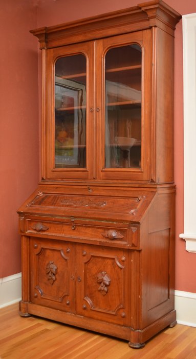 VICTORIAN WALNUT DROP FRONT SECRETARY: VICTORIAN WALNUT DROP FRONT SECRETARY: Stepped pediment, 2 glass doors with 3 wood shelves. Slant front opens to pigeon holes, 2 drawers and shaped valence with birds eye maple veneer, green felt writ