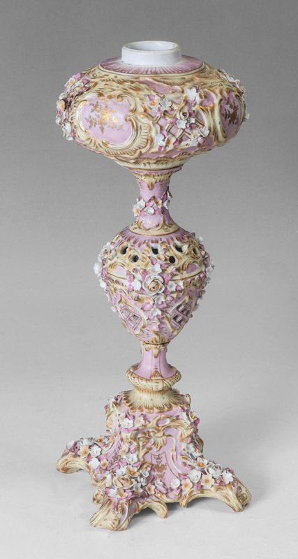 GERMAN ANTIQUE PORCELAIN OIL LAMP BASE: GERMAN ANTIQUE PORCELAIN OIL LAMP BASE: Pink ground with gilt and applied flowers decoration. Overall measures 17 1/2" h. x 6 1/2" x 6 1/2".