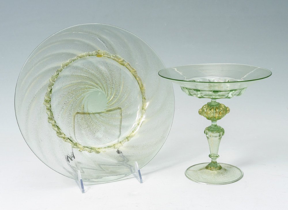 2 pc SALVIATI VENETIAN GLASS COMPOTE & UNDERPLATE: 2 PIECE SALVIATI VENETIAN GLASS COMPOTE AND UNDERPLATE: 2 pieces total with green aventurine glass to include 1) compote with shaped pedestal support, overall 7'' h. x 7'' dia. 2) Underplate with swir