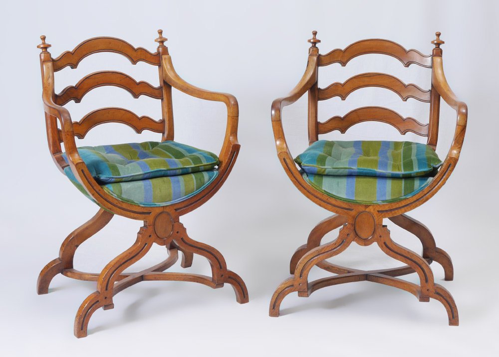 PAIR OF SAVONAROLA STYLE CHAIRS: PAIR OF SAVONAROLA STYLE CHAIRS: Shaped 3 rung ladder back and arms. Carved curved ''X'' shaped base seat and legs, striped upholstery. Overall measures 35'' h. x 23'' x 19''.