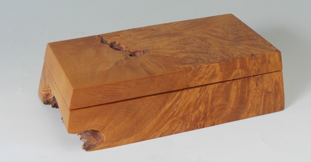 MICHAEL ELKAN BURL BIRDSEYE MAPLE DESK BOX: MICHAEL ELKAN BURL BIRDSEYE MAPLE DESK BOX: Carved with natural inclusions and grain, hinged top with recessed interior, oddly perfect size for an iPhone 6s, base with fitted compartments with lid. Si