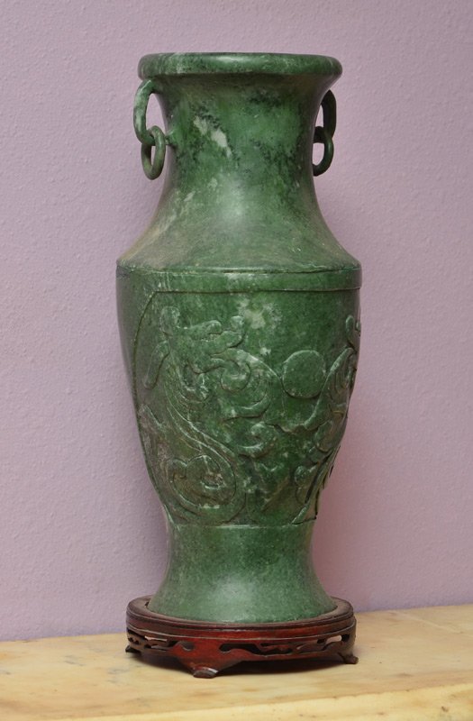 LARGE CARVED SOAPSTONE VASE: LARGE CARVED SOAPSTONE VASE: Baluster form variegated green soapstone with carved figural dragons on body, 2 handles with rings. Overall measures 15 5/8'' x 6 1/2''. Sold with a carved wood stand, 1 1