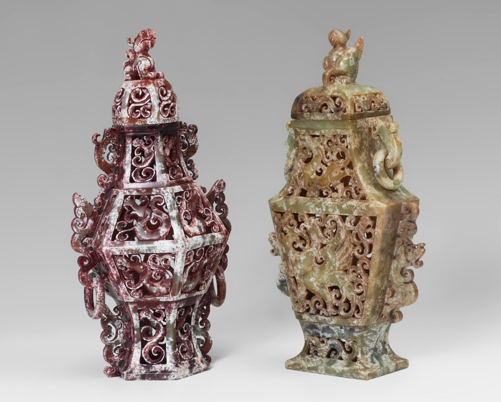 2 CARVED & PIERCED SOAPSTONE COVERED JARS: 2 CARVED & PIERCED SOAPSTONE COVERED JARS: 2 pieces total to include 1) Rectangular with bird finial on lid, ring handles, 10 3/4" h. x 6" x 2 1/2". 2) Octagonal body with foo dog finial, ring handles