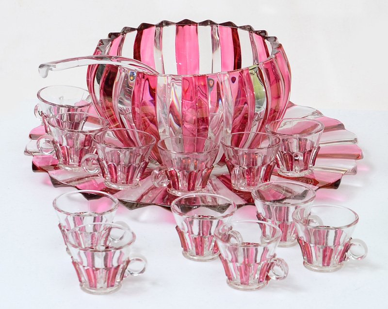 CRANBERRY STRIPED PUNCH BOWL SET: CRANBERRY STRIPED PUNCH BOWL SET: Flashed cranberry stripes on alternating ribs, 15 pieces total to include 1) Punch bowl, 6" h. x 10 1/4", 12 cups, 2 3/8" x 3 1/4", underplate 1 1/8" x 17 1/4", clear