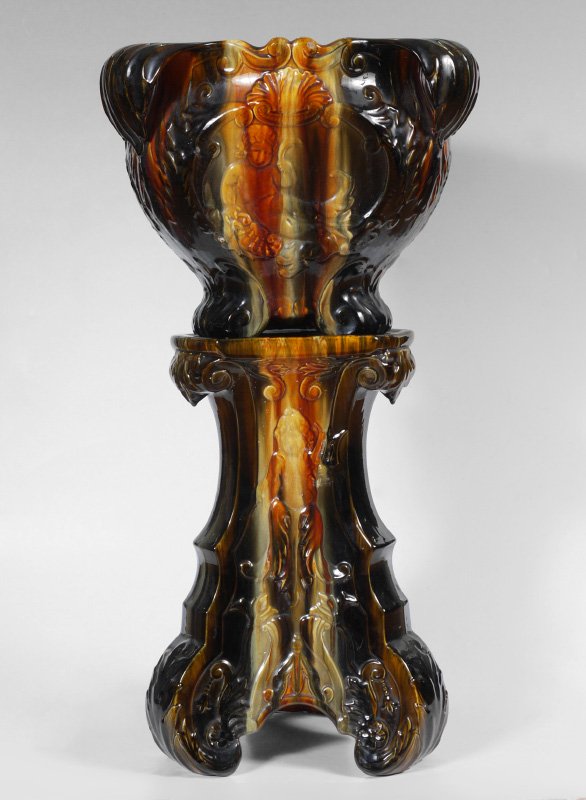 J.B. OWENS MERMAID POTTERY JARDINIERE/PEDESTAL:: J.B. OWENS POTTERY JARDINIERE AND PEDESTAL: Glossy earth tone glazes, 3 sided jardiniere with relief figural mer-child and shell motifs. Incised 493 on base. Measures 13 1/2'' h. x 16 1/2''. Pedestal 