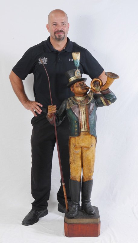 GERMAN CARVED PAINTED FIGURAL RINGMASTER: GERMAN CARVED PAINTED FIGURAL RINGMASTER: Figure of a circus ringmaster holding a whip in one hand and carved horn in the other. Signed by German Bavarian artist M. Rohlr, Berchetsgaden. Overall measu