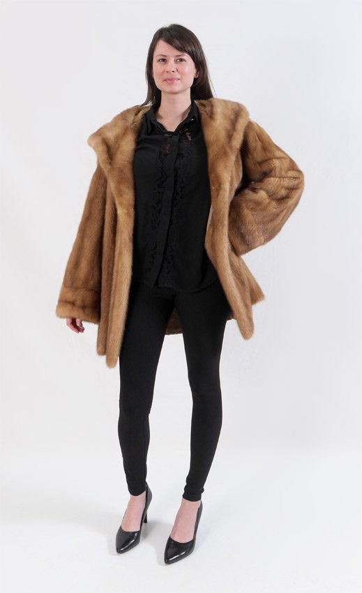 MINK FUR SWING COAT: CARAMEL MINK FUR SWING COAT: Caramel color swing length coat with generous collar and bell sleeves. Maintained in cold storage. Medium to large size measures approx. 32" collar to hem, 18" shoulder to
