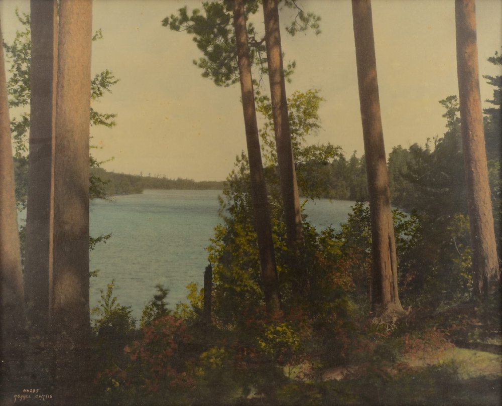 ASAHEL CURTIS NORTHERN PACIFIC RAILROAD POSTER: CURTIS, Asahel, (American, 1874-1941): Large format photographic promotional poster of Lake Itasca in Minnesota, framed with plaque marked "Itaska (misspelled on plaque) Lake, Through the Pines, North
