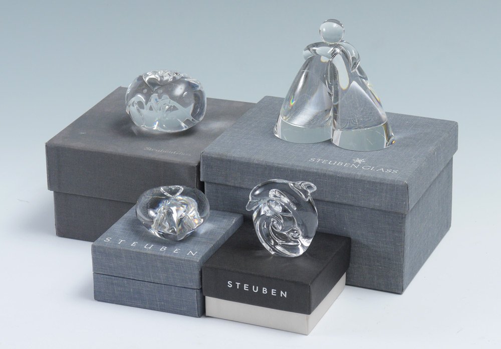 4 PIECE STEUBEN CRYSTAL: 4 PIECE STEUBEN CRYSTAL: An assembled collection, all with original boxes to include 1) "Heart to Heart" shaped paper weight, 2 1/2". 2) Dolphin paperweight, 2 5/8" h. 3) Figural birds and heart shape