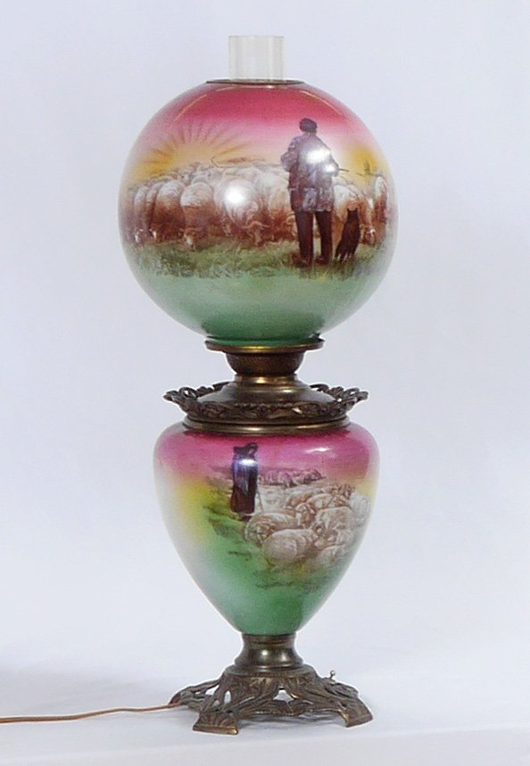 UNUSUAL SHEEP MOTIF GONE WITH THE WIND LAMP: UNUSUAL SHEEP MOTIF GONE WITH THE WIND LAMP: Body and shade decorated with unusual shepherd and sheep at sunrise motif, cast metal base, electrified with single socket. Overall measures 25" h. to top