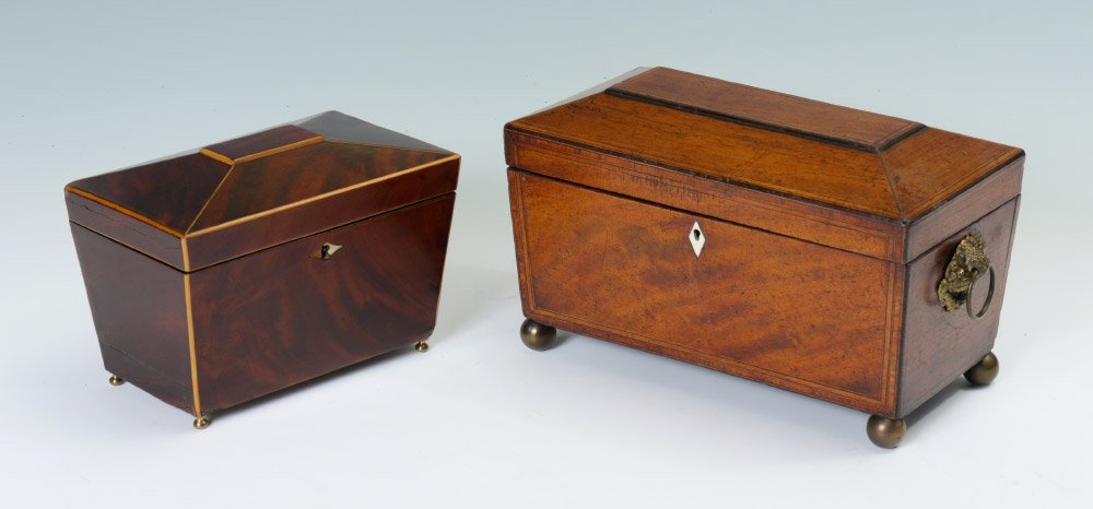 2 ANTIQUE TEA CADDY BOXES: 2 ANTIQUE TEA CADDIES 1) Richly grained mahogany, sarcophagus form with hinged lid and 2 lidded interior compartments. Bone escutcheon, brass ball feet, no key. Overall measures 6"h. x 8 3/4" x 5 1/4"