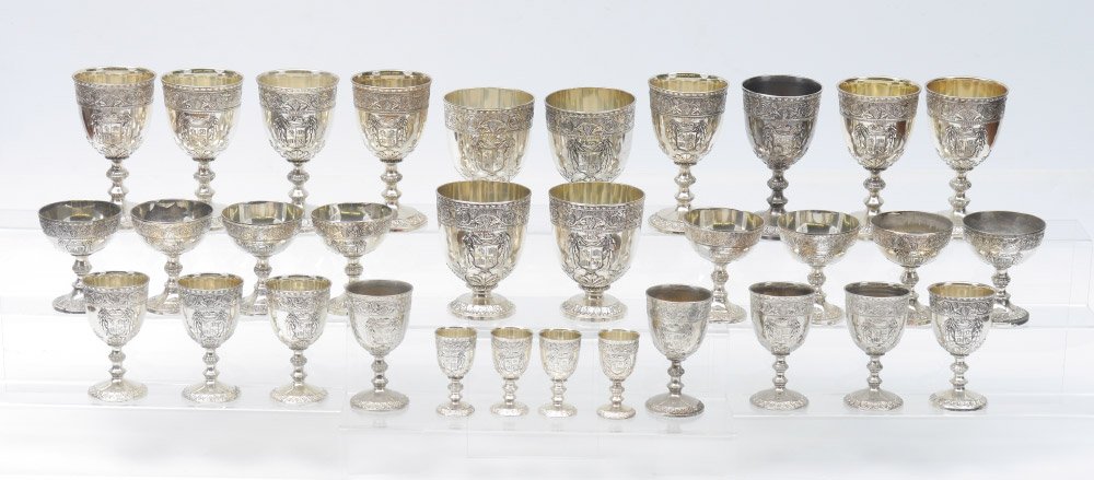 LARGE ELKINGTON SILVERPLATE STEMWARE SET: LARGE ELKINGTON SILVERPLATE STEMWARE SET: Approx. 32 pieces by Elkington & Co. with grape vine motif rim, heraldic crest medallion, floral base, to include 8 goblets (6 1/2" h.), 4 wide goblets (5 1/4