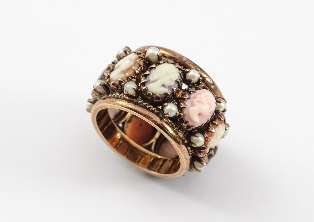 9 CAMEO BAND RING 14K GOLD: 14K CAMEO RING: An unusual 14K gold band ring, 16 mm wide, prong set with 9 carved shell cameos and seed pearls. Weight: 14.6 grams inclusive. Size: 8