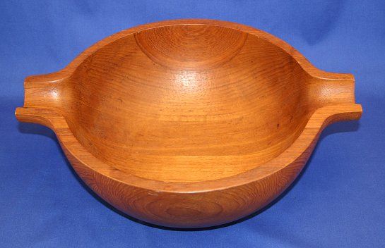GEORG JENSEN HENNING KOPPEL TEAK BOWL: GEORG JENSEN HENNING KOPPEL TEAK BOWL: Round bowl with scoop handles, signed on bottom Georg Jensen Henning Koppel Design Made in Denmark, approx. 11 5/8" x 14 1/2" x 4 3/4"d.