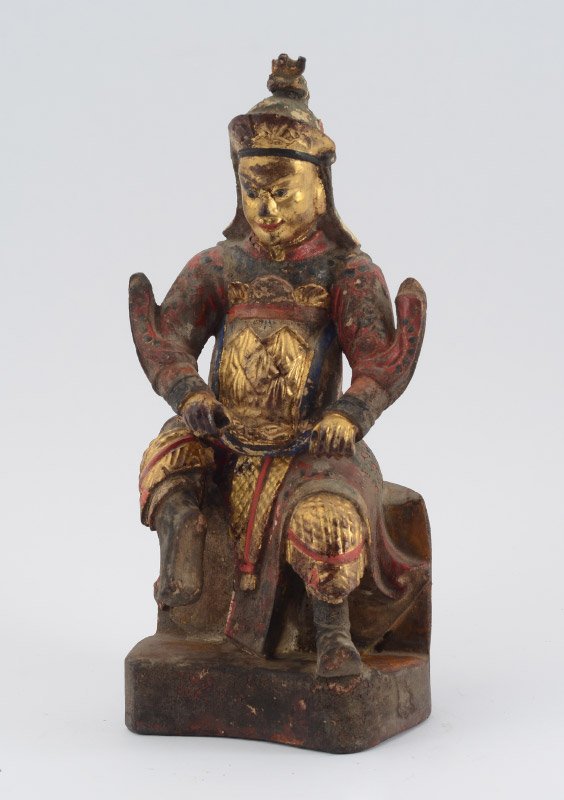 CHINESE PARCEL GILT CARVED WOOD WARRIOR: CHINESE PARCEL GILT CARVED WOOD WARRIOR: 19th century figure of a seated warrior holding a polearm, parcel gilt and polychrome decoration. Back covered opening sealed closed. 11 1/2'' h. x 5 1/4'' x 4
