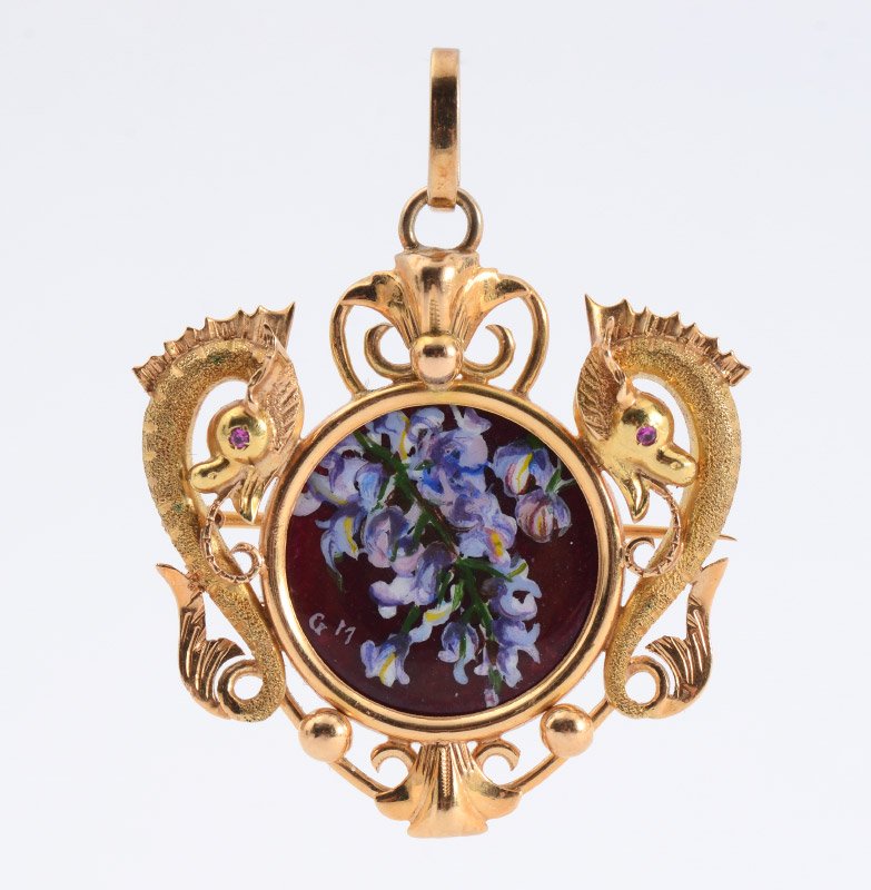 18K GOLD ENAMELED DRAGON BROOCH PENDANT: 18K ENAMEL DRAGON MOTIF PENDANT BROOCH: 18K yellow gold pendant of two dragons guarding over a floral motif enamel disc. Two 1.00 mm rubies are deep set as the dragon's eyes. Bar pin closure and bail.
