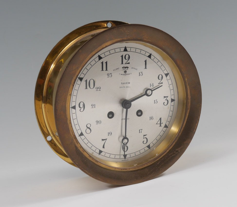 SALEM BRASS SHIPS BELL CLOCK: SALEM BRASS SHIPS BELL CLOCK: Mid 20th century, brass case, silvered dial marked Salem Ships Bell, Jeweled. Overall 2 3/4" x 7" dia.