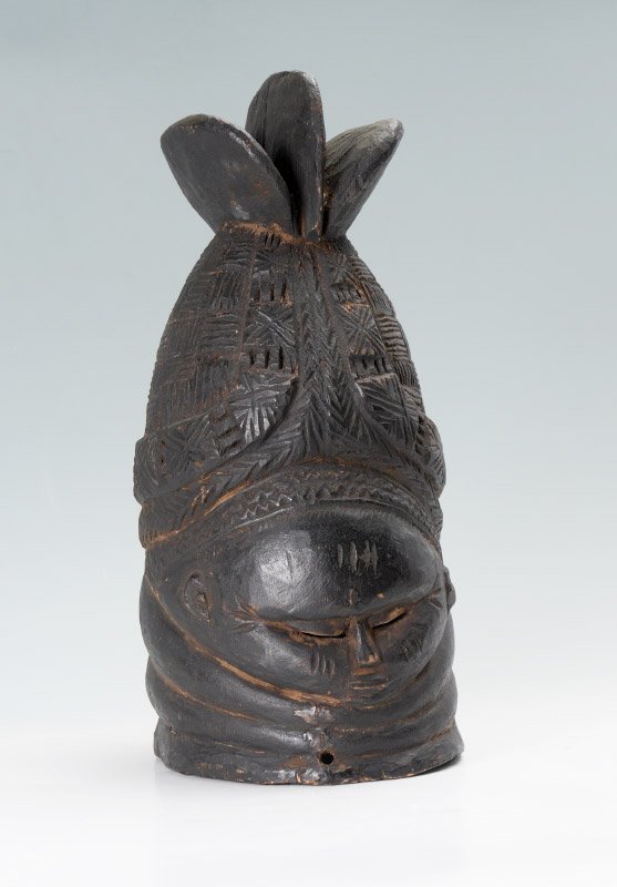 CARVED AFRICAN MENDE TRIBE HELMET MASK: CARVED AFRICAN MENDE TRIBE HELMET MASK: Carved wood with figural face, Mende tribe for the Sande Society, Sierra Leone. Overall measures 16 1/2" h. x 6 1/2" x 9".