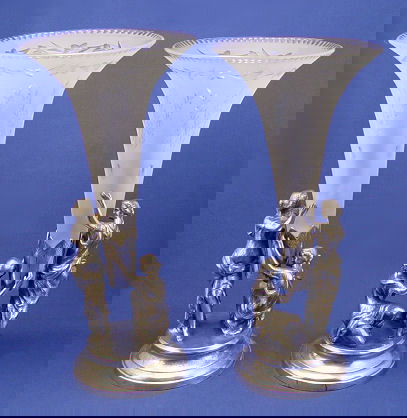 PR WILCOX VICTORIAN SILVER PLATE FIGURAL EPERGNES: PR WILCOX VICTORIAN SILVER PLATE FIGURAL EPERGNES: By Wilcox Silver Plate Co., each with 2 figures supporting the original etched satin glass trumpet vases. 18 1/2'' and 18''h., the trumpet is 8'' dia