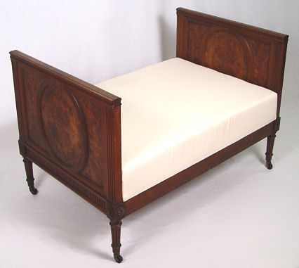 DIMINUTIVE FRENCH LOUIS XVI STYLE DAY BED: DIMINUTIVE LOUIS XVI STYLE DAY BED: Mahogany frame, reeded legs ending in brass casters. 27"h. x 40"l, x 25". The cushion is 16" from the floor.