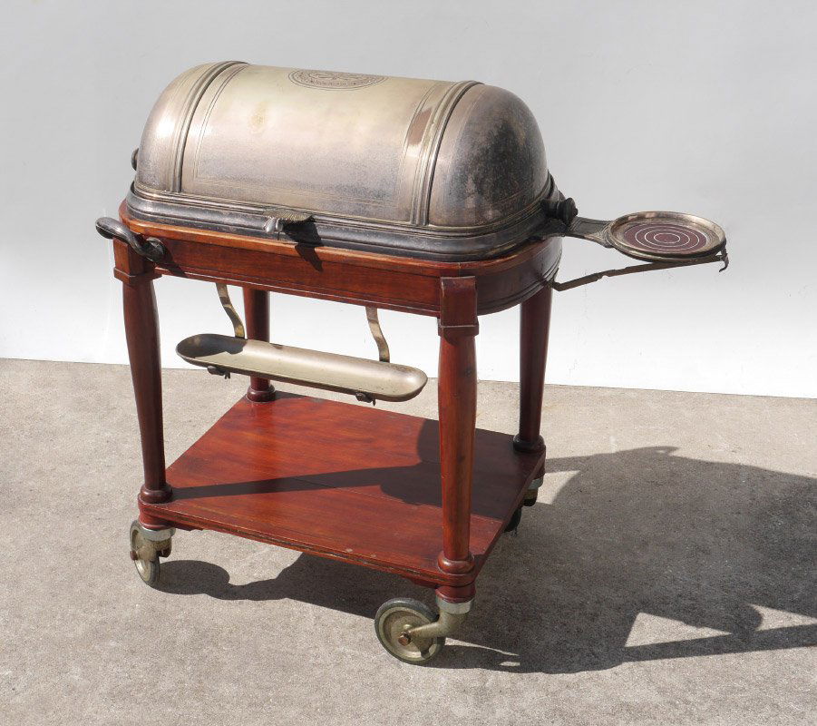 VICTORIAN ROLL TOP CARVING & SERVING TROLLEY: VICTORIAN ROLL TOP CARVING & SERVING TROLLEY: Silverplate roll top opens to carving platter and 2 sauce bowls, over deep well with burner. Folding side shelf, lower burner and drip tray. Mahogany fram