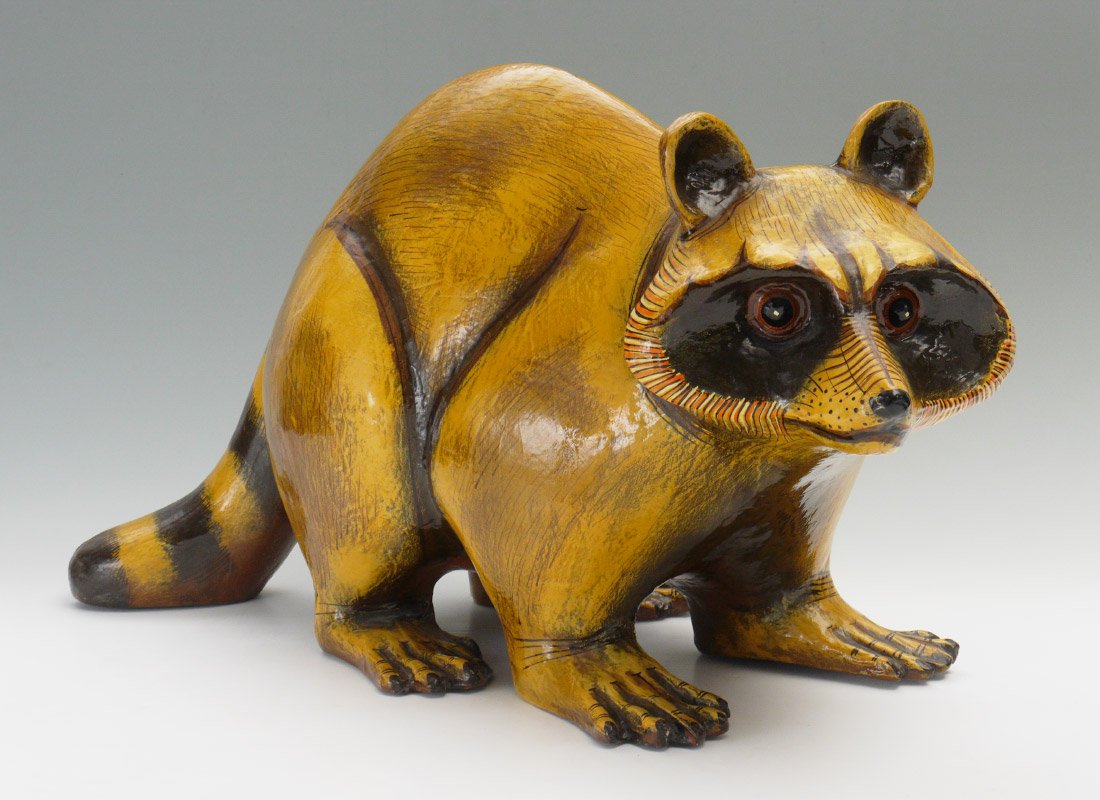 BUSTAMANTE RACCOON SCULPTURE: BUSTAMANTE, Sergio (Mexican, 1942-): "Raccoon", Paper Mache, 25.25" x 42" x 19", signed and numbered 60/100.