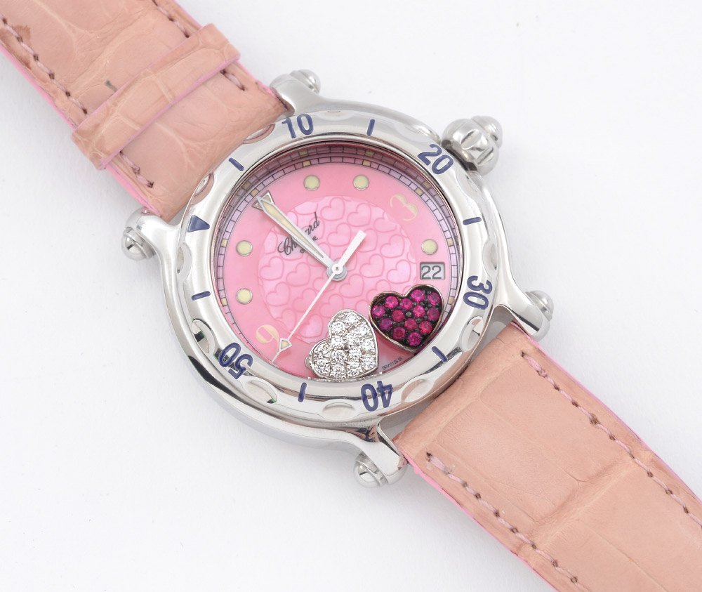 CHOPARD HAPPY SPORT RUBY & DIAMOND HEARTS WATCH: CHOPARD HAPPY SPORT LADIES WATCH: Featuring floating ruby and diamond hearts, stainless case, pink mother of pearl dial embossed with hearts, luminescent hands, date window between 4 and 5. Original p