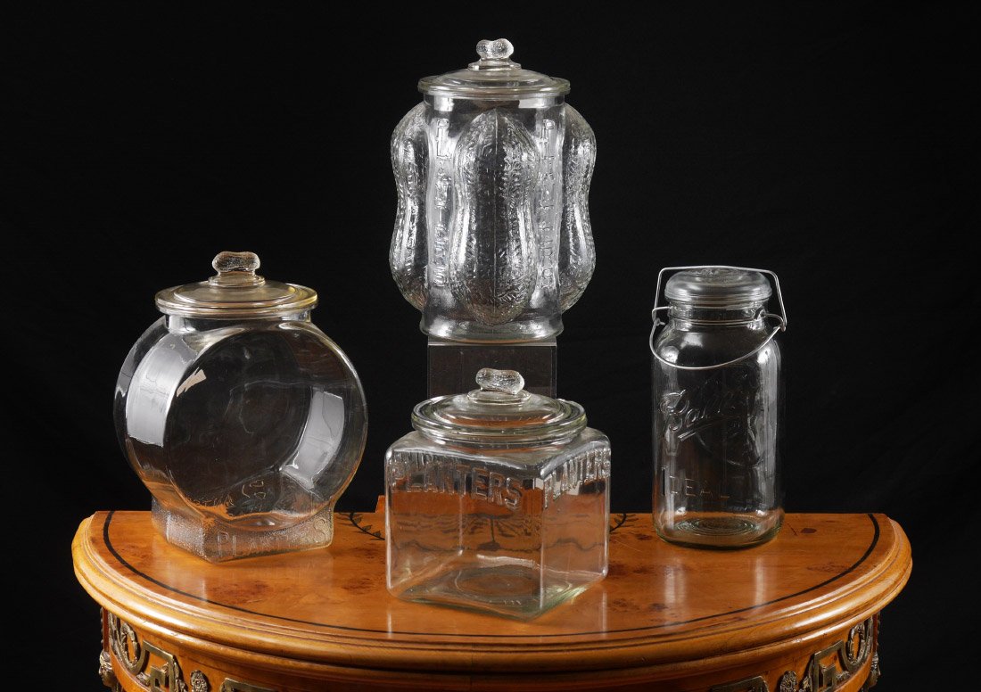 3 EMBOSSED PLANTERS ADVERTISING JARS: 3 EMBOSSED PLANTERS ADVERTISING JARS: 4 jars total, 3 for Planters Peanuts to include 1) Body with embossed peanuts on all 4 corners, lid with peanut finial, overall measures 14 1/2'' h. x 8'' x 8''. 