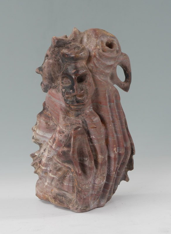 CENTRAL AMERICAN CARVED STONE EFFIGY: CENTRAL AMERICAN CARVED STONE EFFIGY: Figures of faces and parrot, Central American, most likely Honduras, actual age unknown. 9'' h. x 5 1/4'' x 5''.