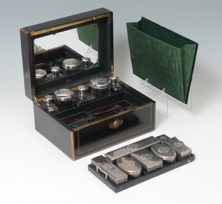 TAHAN FRENCH INLAID TRAVEL VANITY BOX: TAHAN FRENCH INLAID TRAVEL VANITY BOX: Ebonized wood box with brass inlaid medallion on hinged lid and brass trim inlay, marked Tahan A Paris. Fitted compartments with French Minerva silver marked lid
