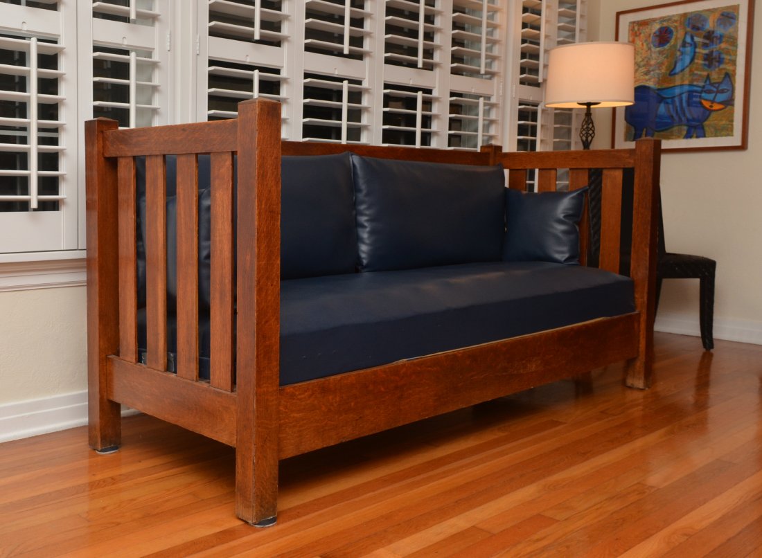 STICKLEY BROTHERS ARTS & CRAFTS PERIOD OAK SETTLE: ARTS & CRAFTS PERIOD OAK SETTLE: Oak settle, even top back and arm rails, Stickley Brothers paper label taped to inside side base rail. Blue leather set cushion, approx. 39'' h. x 80'' x 30''.