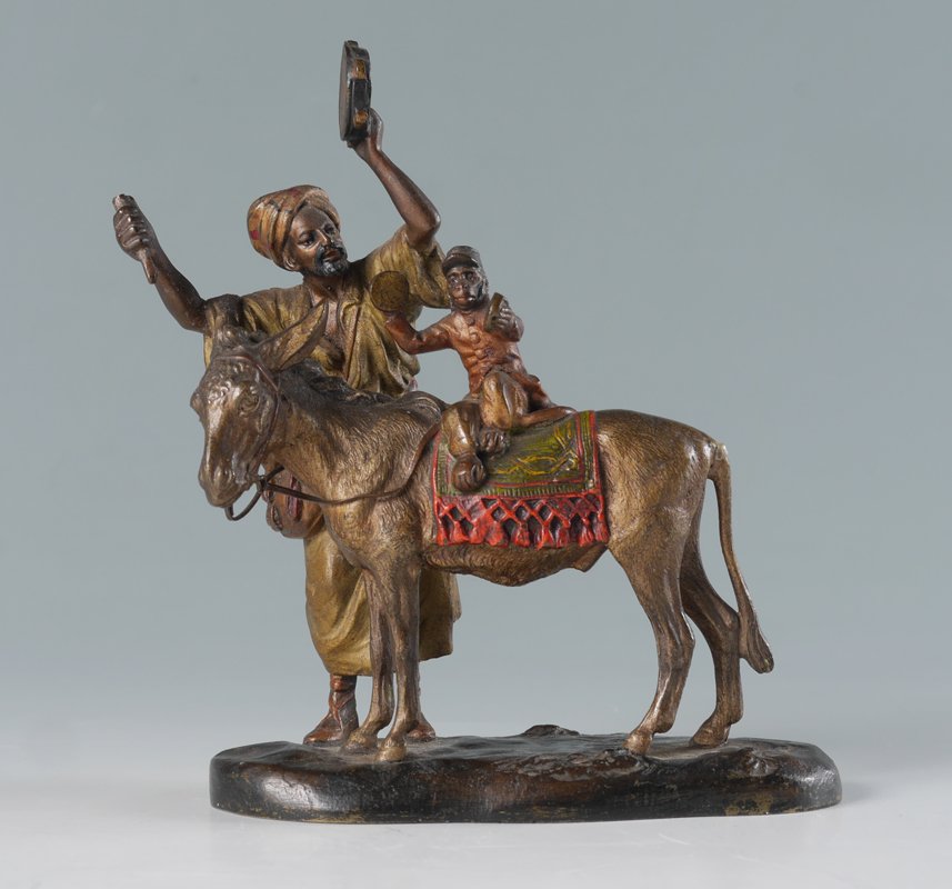 ANTON CHOTKA MUSICIAN COLD PAINTED AUSTRIAN BRONZE: CHOTKA, Anton, (Austrian, 1881-1955): Unsigned attribution, cold painted bronze figure of a musician and his monkey on a donkey's back. Identical to signed examples on lamps by Chotka. Overall measure