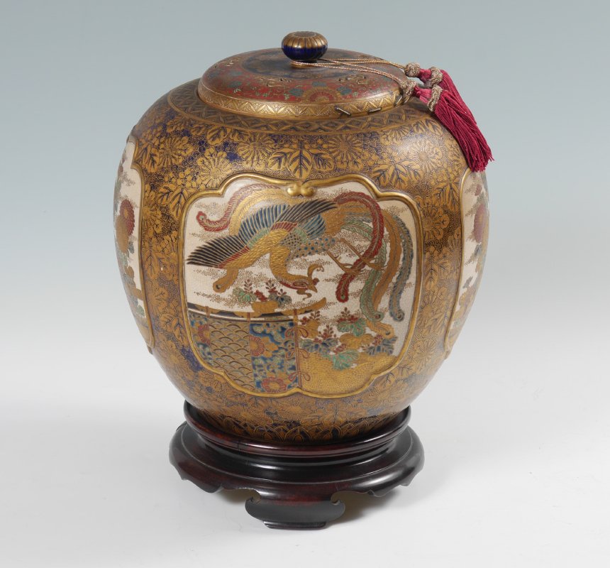 SHIMAZU JAPANESE SATSUMA COVERED JAR: SHIMAZU JAPANESE SATSUMA COVERED JAR: Ovoid shape, gold and cobalt blue floral ground with floral motifs in reserves. Pierced lid with incised finial, staple repairs. Marked on base, overall 13'' h. x
