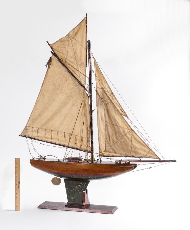 19TH CENTURY GAFF RIGGED POND BOAT ON STAND: 19TH CENTURY GAFF RIGGED POND BOAT ON STAND: Shaped and painted with striped mast, red deck, red and green painted below water line and keel. Stitched linen sails, nicely detailed. Overall on stand me